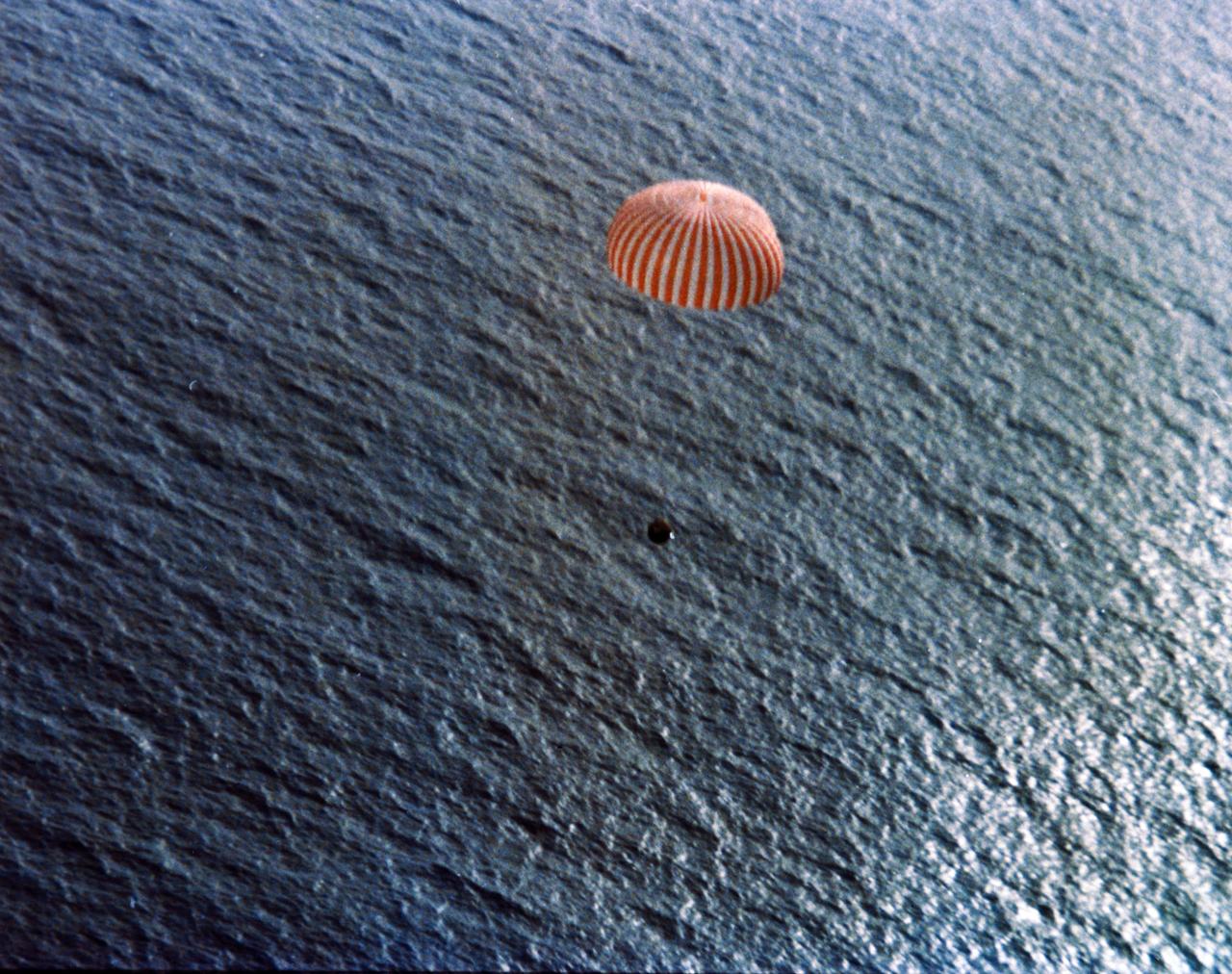 Gemini 7 capsule descending by parachute at the end of its mission