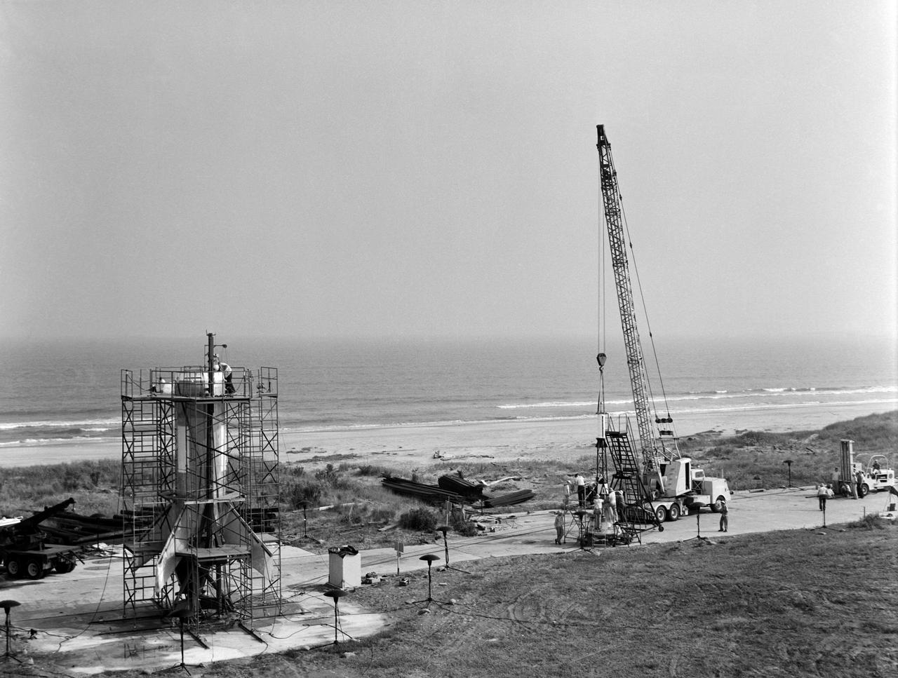 Technicians attaching the Mercury escape tower before assembly with a Little Joe launcher