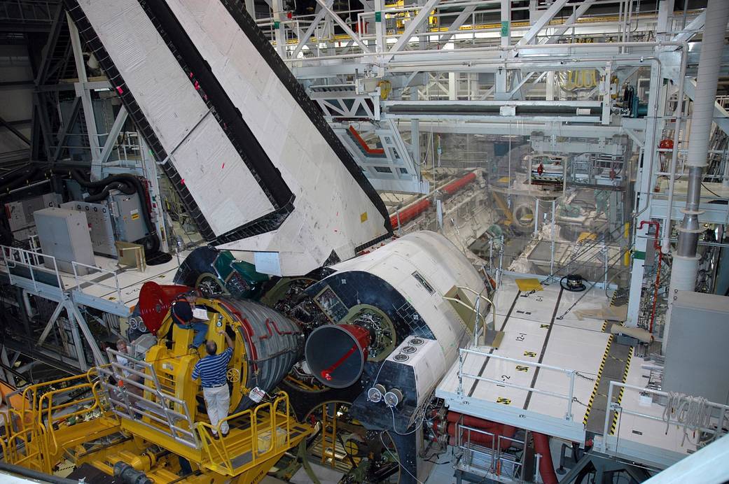 NASA technicians install an RS-25 Space Shuttle Main Engine in Endeavour for STS-123